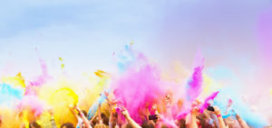 Happy , celebrants with smart phones dancing during the color Holi Festival
