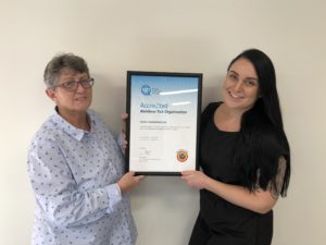 Image of Carers Queensland staff with Certificate