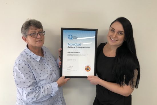 Image of Carers Queensland staff with Certificate