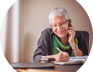 Header image of older lady on phone at a desk