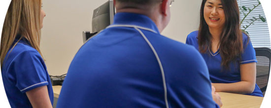 Header image of QIP staff at desk