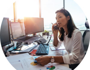 Header image of woman at desk on phone
